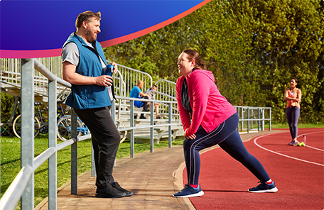 Two patients with diabetes walking at an outdoor track